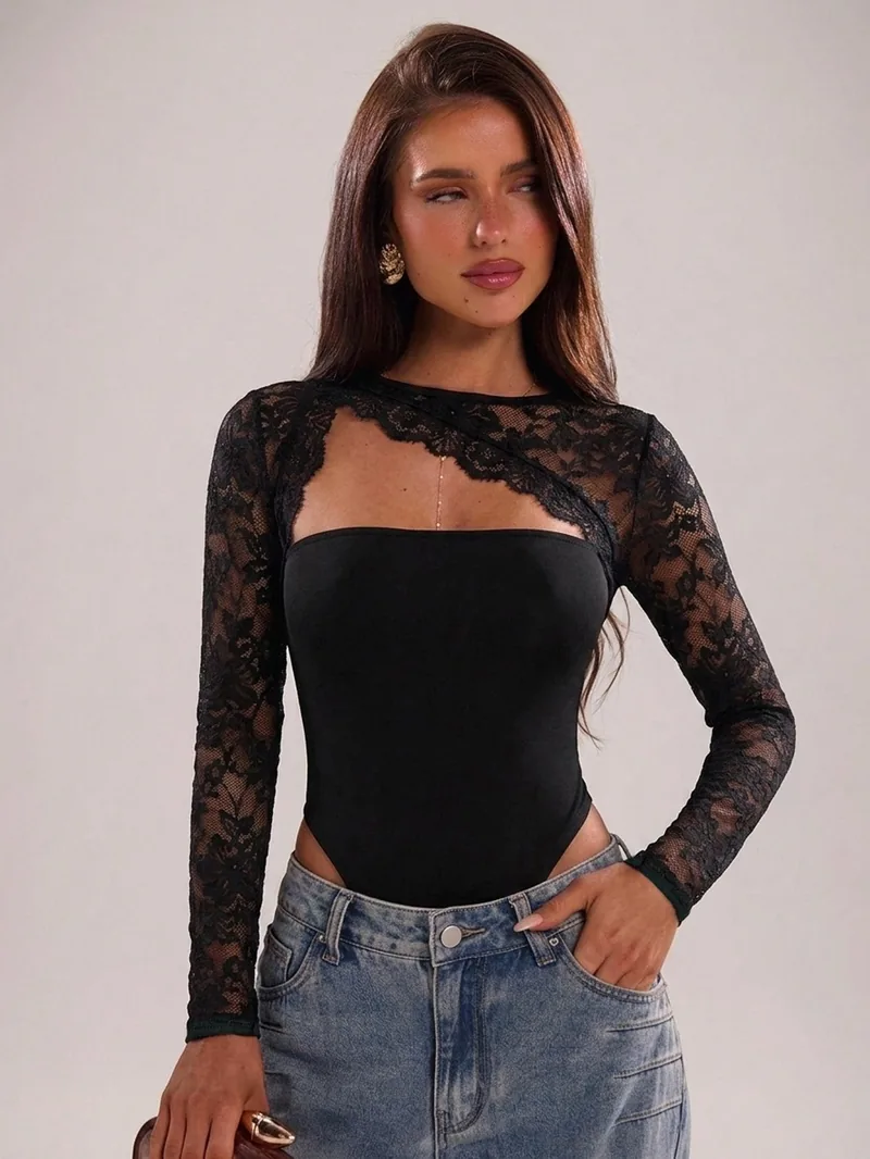 Black top with a solid body and floral lace at the shoulders and sleeves